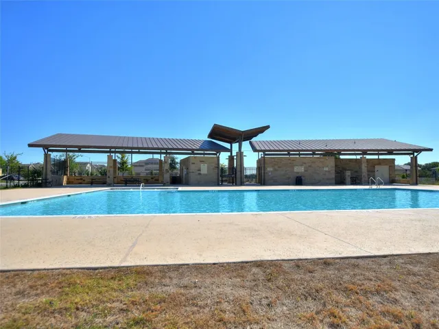 a view of a garden with a building in the background