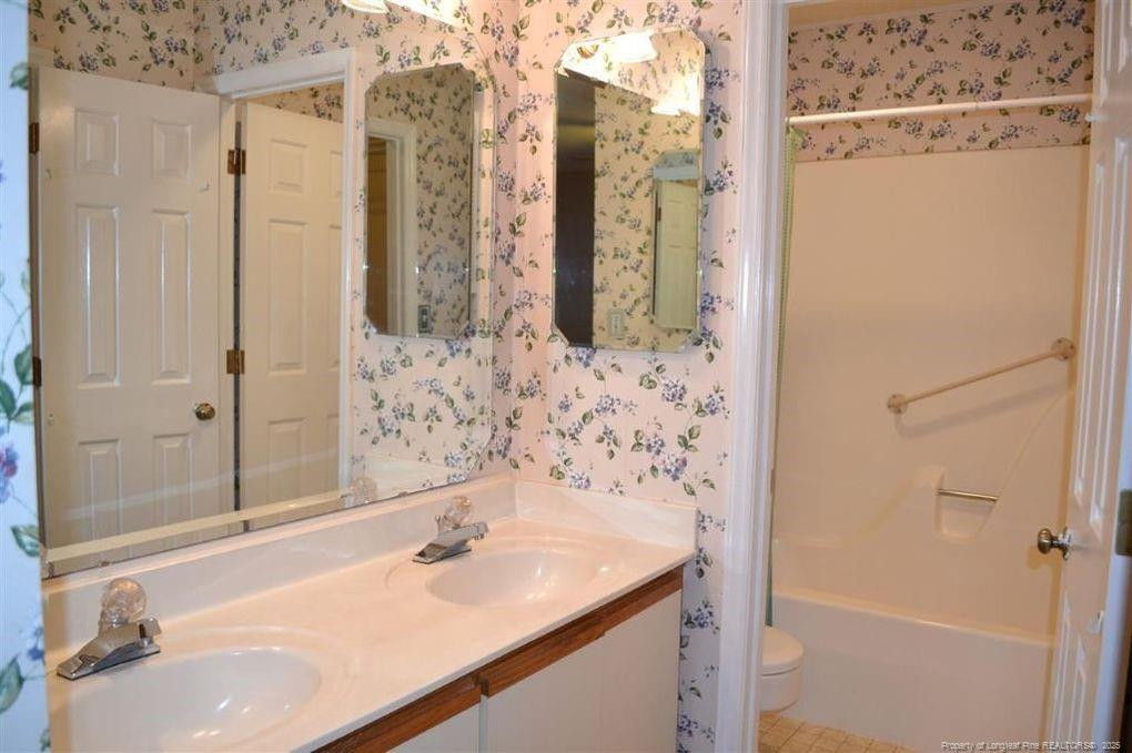 158 Cranes Cove Vass, NC 28394 - Photo 14 of 19 a bathroom with a sink and a mirror