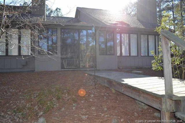 158 Cranes Cove Vass, NC 28394 - Photo 3 of 19 a view of a backyard with brick wall and potted plants