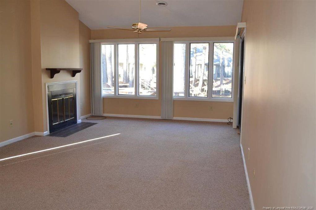 158 Cranes Cove Vass, NC 28394 - Photo 7 of 19 a view of an empty room with a fireplace and a window