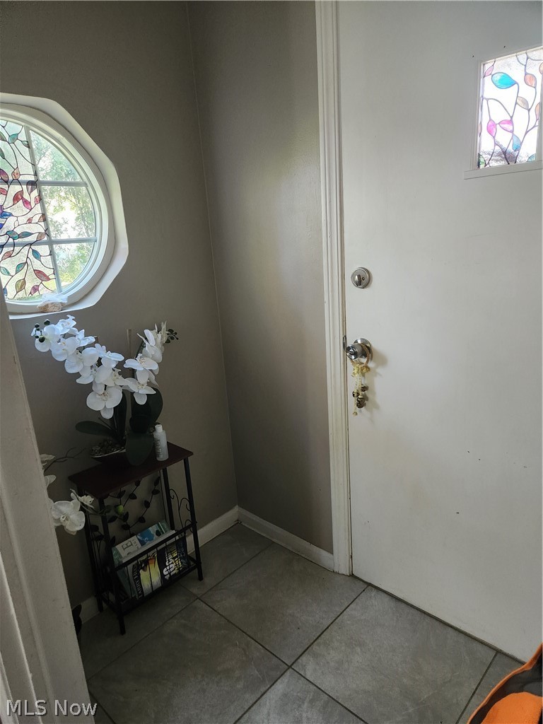 1025 Hereford Road Cleveland, OH 44112 - Photo 5 of 18 Doorway to outside featuring tile flooring