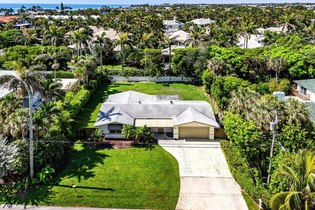 an aerial view of a house with garden space and street view