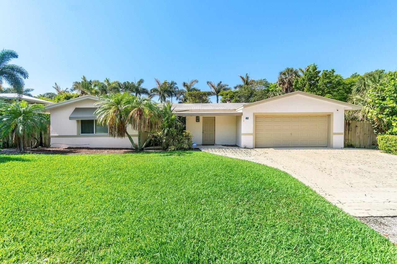 19 Harbour Drive South Ocean Ridge, FL 33435 - Photo 9 of 9 a front view of a house with a garden