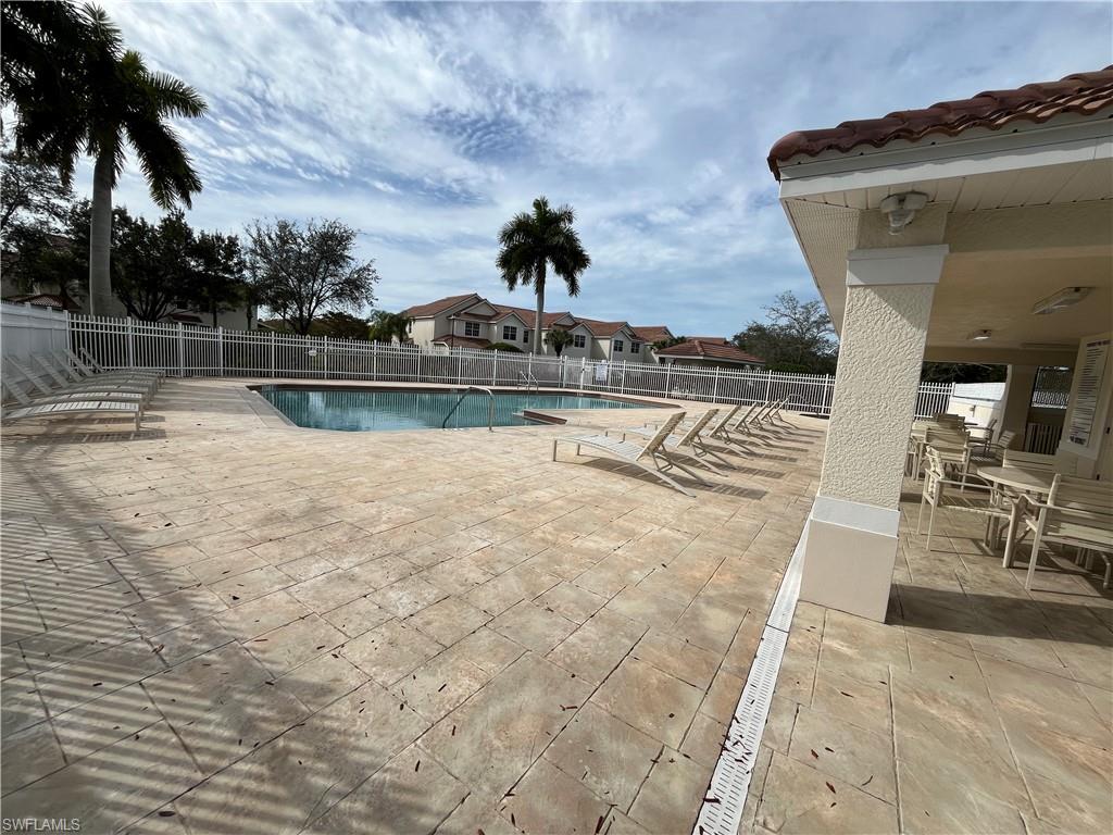 884 Hampton Circle, Unit 159 Naples, FL 34105 - Photo 23 of 28 a view of a swimming pool with a lake view