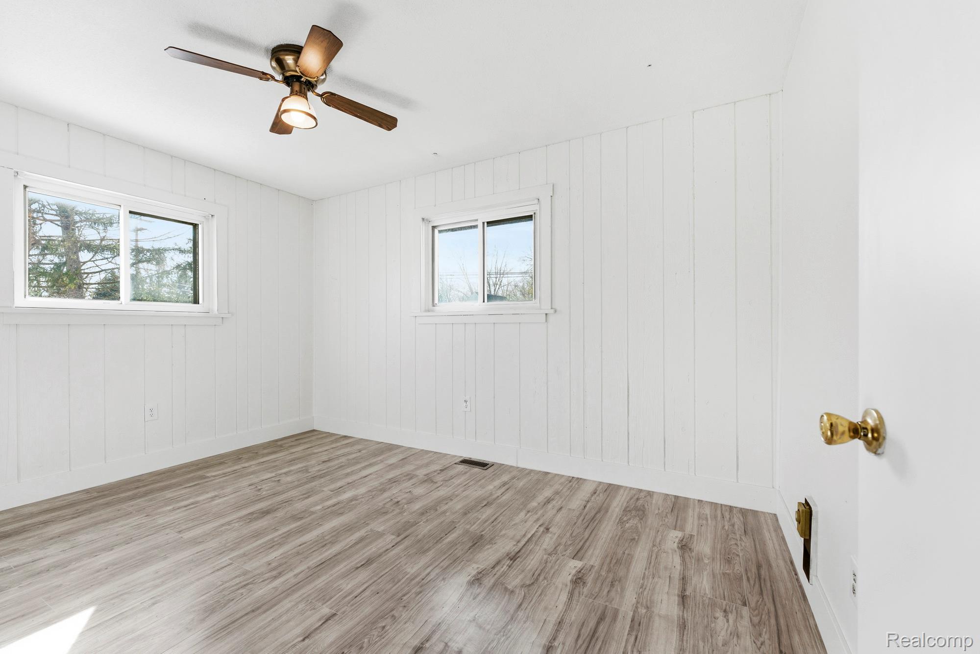 3375 Grant Road Rochester, MI 48309 - Photo 18 of 28 Empty room with light wood finished floors and ceiling fan