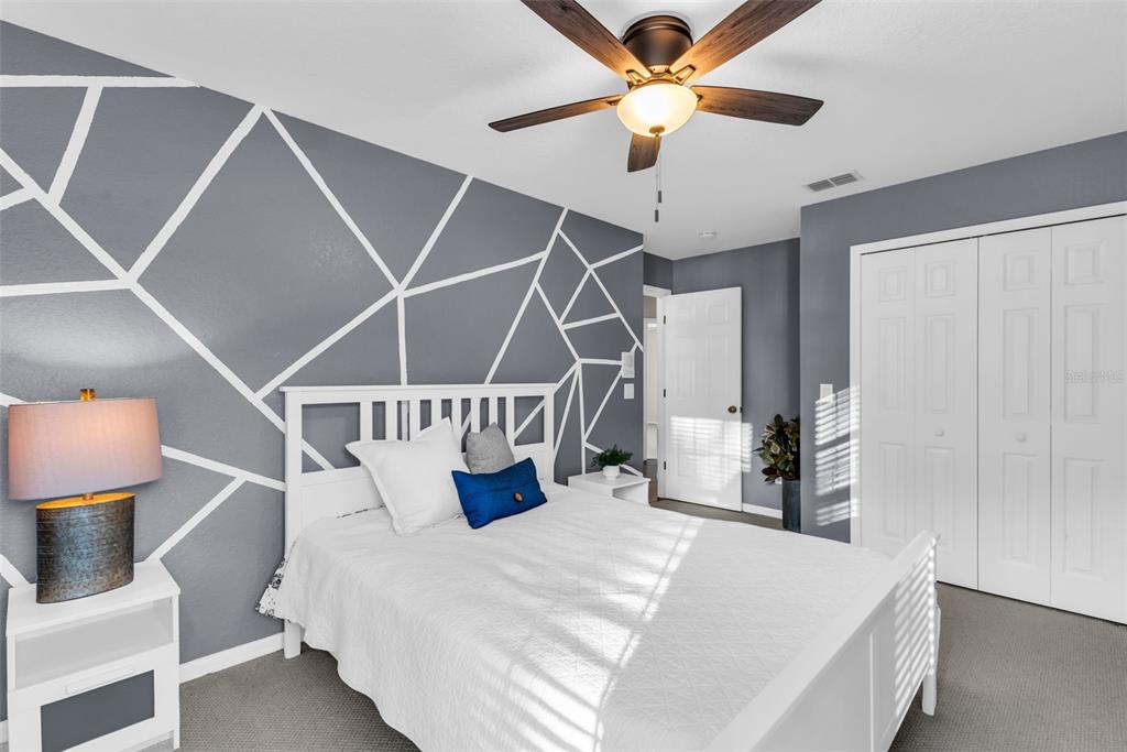 1425 Riviera Drive Kissimmee, FL 34744 - Photo 42 of 82 a bedroom with a bed and a chandelier