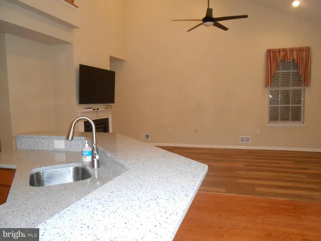 a view of a kitchen with a sink and a kitchen counter top