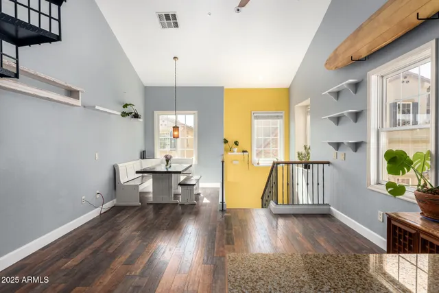 a view of a room with wooden floor furniture and windows