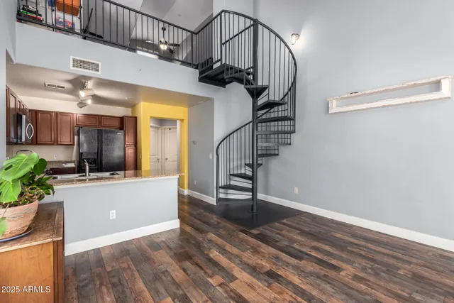 a view of a room with wooden floor and windows