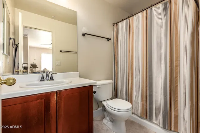 a bedroom with a bed and a mirror