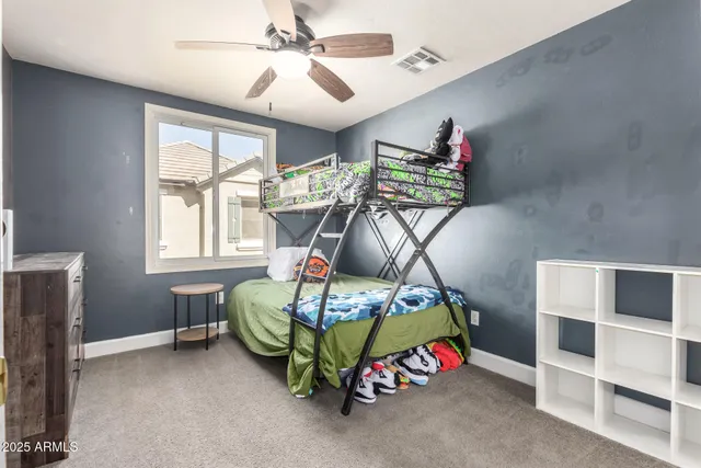a bedroom with furniture and a flat screen tv