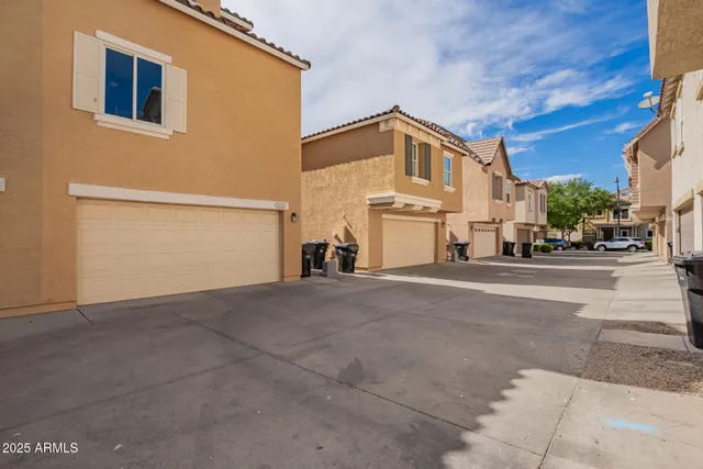 a living room with furniture a flat screen tv and a couch