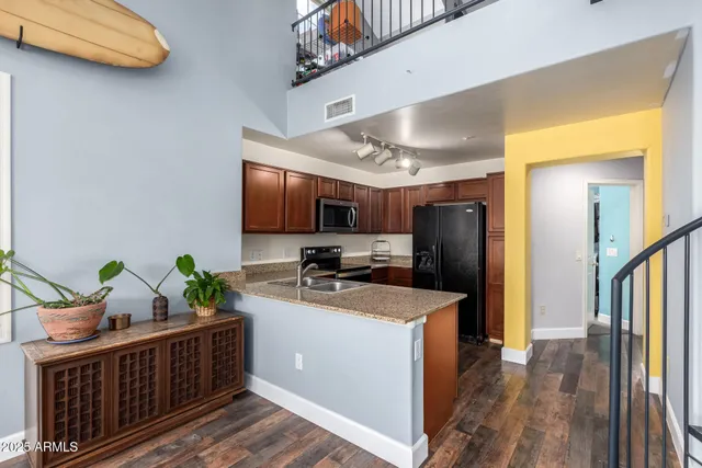 a living room with wooden floor and a table