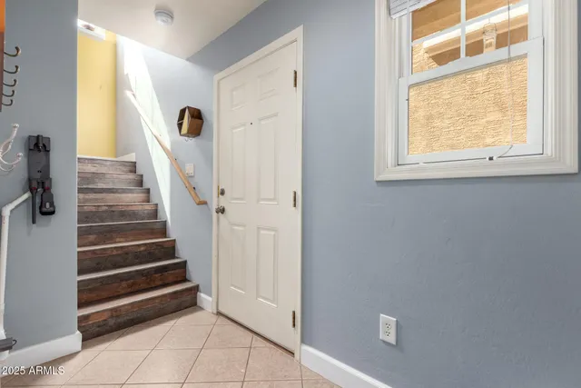 a kitchen with stainless steel appliances a sink a refrigerator a counter top space and cabinets