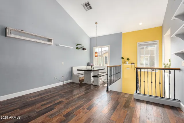 a view of a brick house with a yard and plants