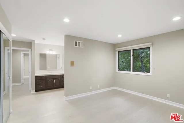 an empty room with windows and closet