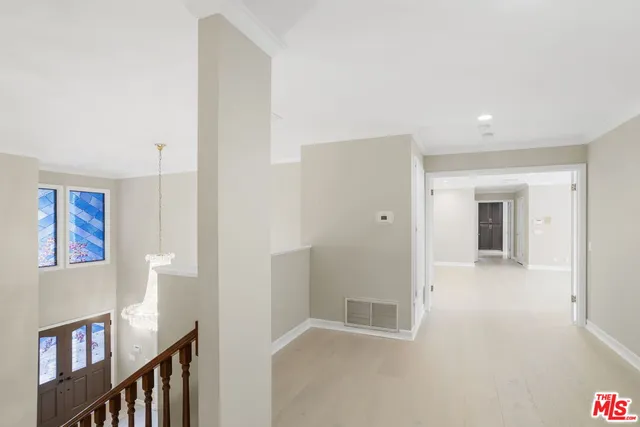 a view of an empty room with a fireplace and a window