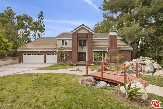 a view of a house with a swimming pool and sitting area