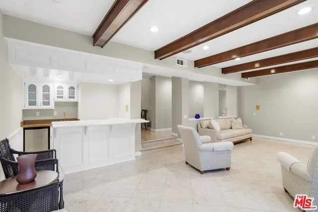 a living room with furniture and a dining table