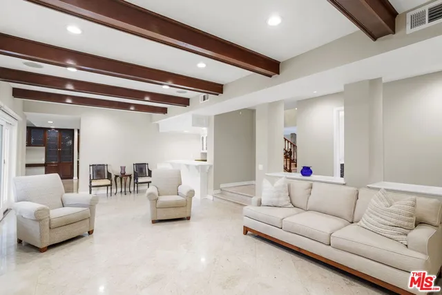 a living room with furniture and white walls