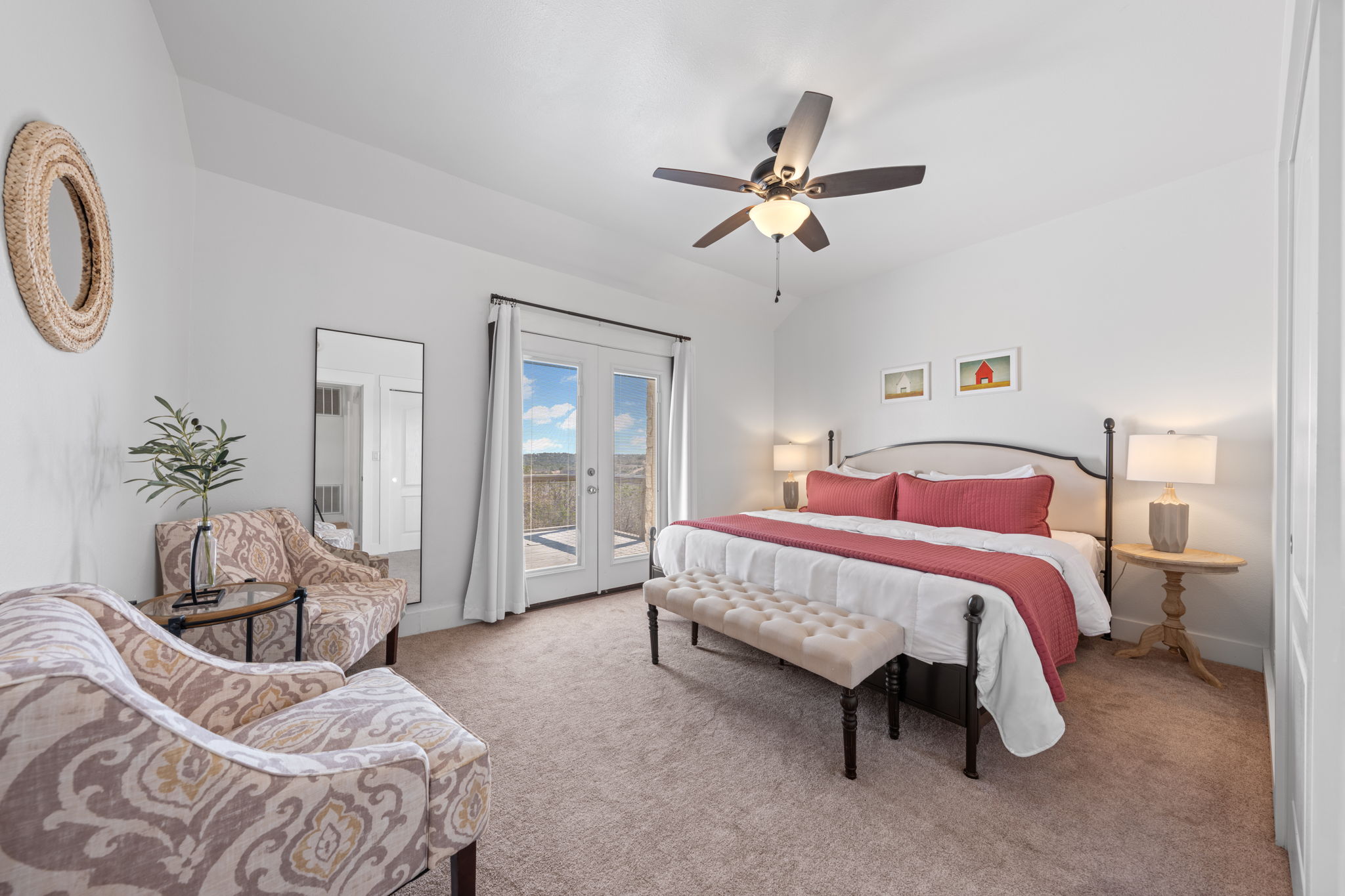 117 Point Road Fredericksburg, TX 78624 - Photo 24 of 40 Bedroom with access to outside, light carpet, a ceiling fan, french doors, and vaulted ceiling
