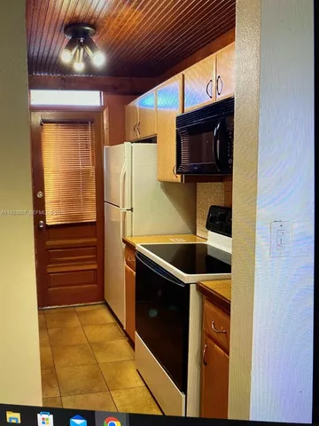 a kitchen with stainless steel appliances granite countertop a sink and a refrigerator