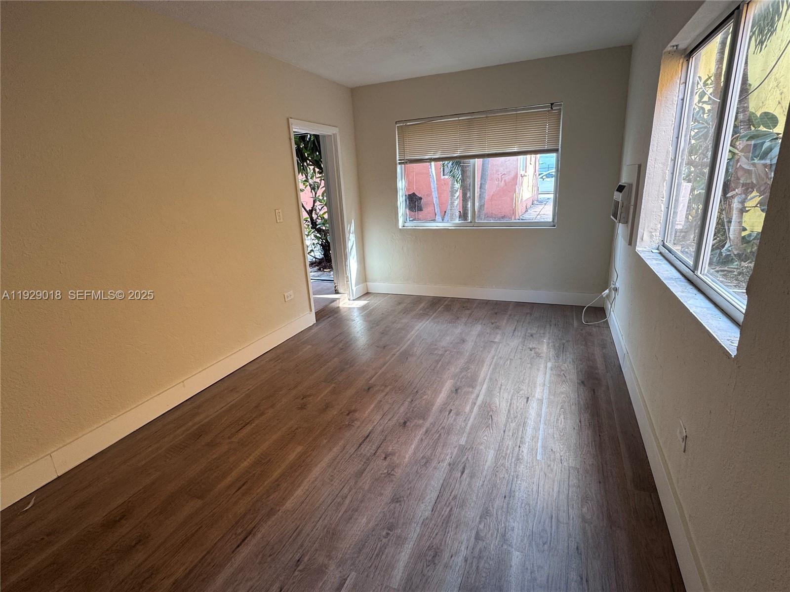 20 Northwest 17th Place, Unit 18 Miami, FL 33125 - Photo 6 of 13 wooden floor in an empty room with a window