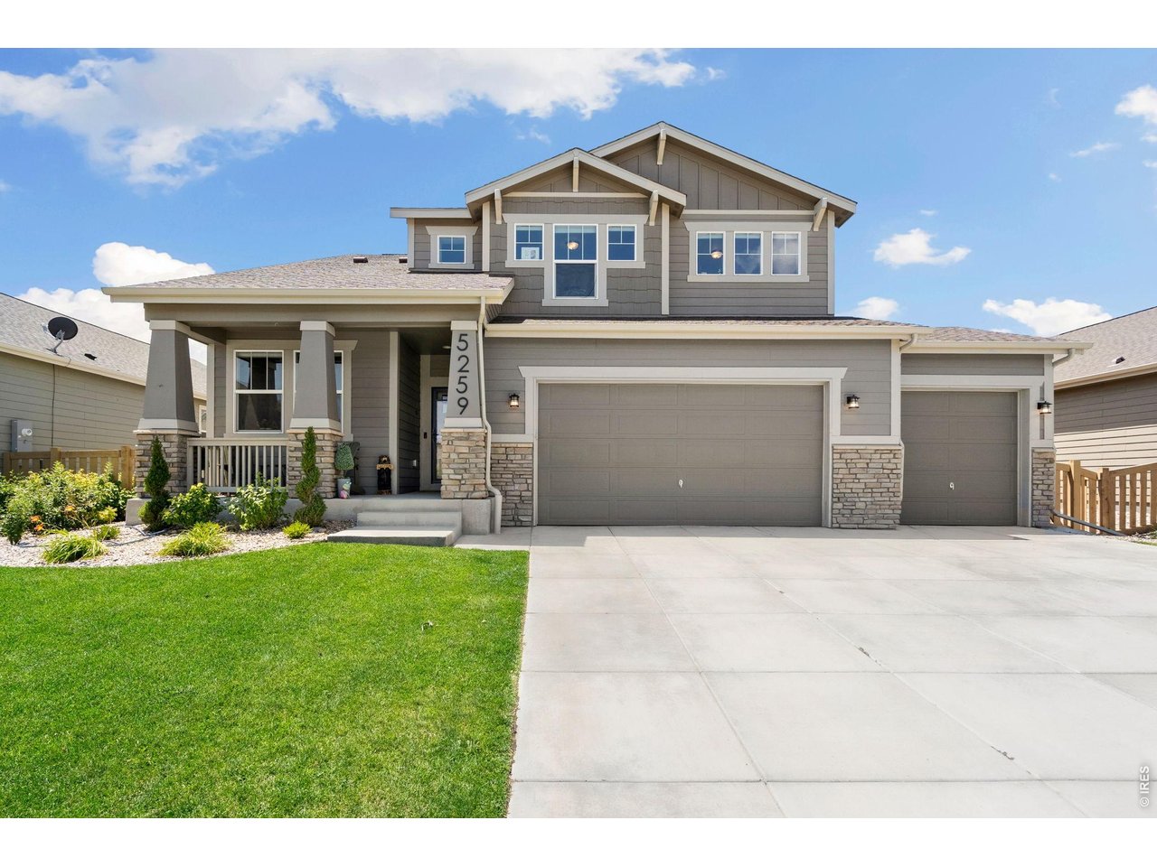 5259 Odessa Lake Street Timnath, CO 80547 - Photo 1 of 30 a front view of a house with a yard and garage