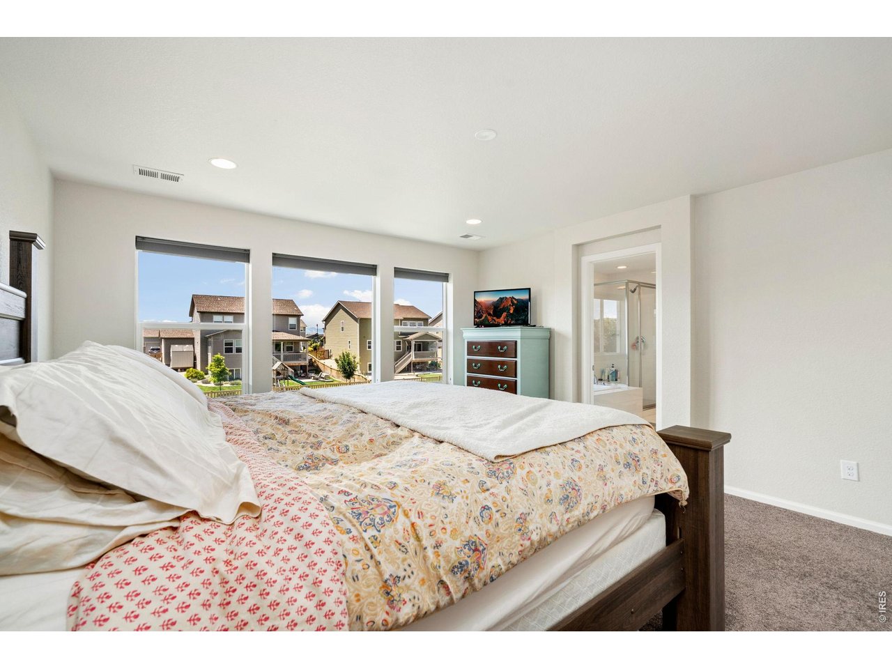 5259 Odessa Lake Street Timnath, CO 80547 - Photo 12 of 30 a bedroom with a large bed and a dresser