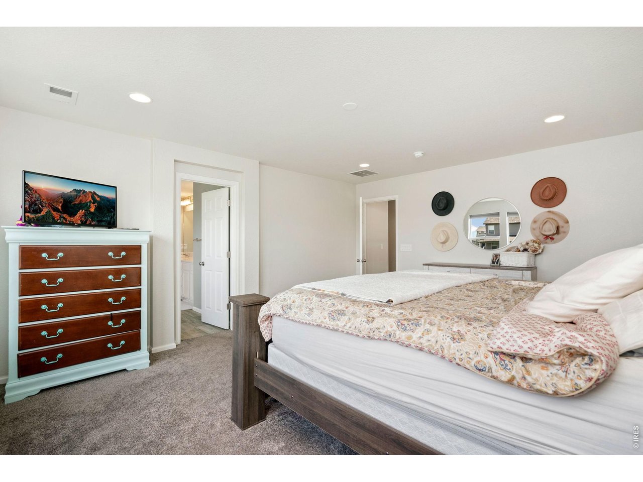 5259 Odessa Lake Street Timnath, CO 80547 - Photo 13 of 30 a bedroom with a bed and a dresser