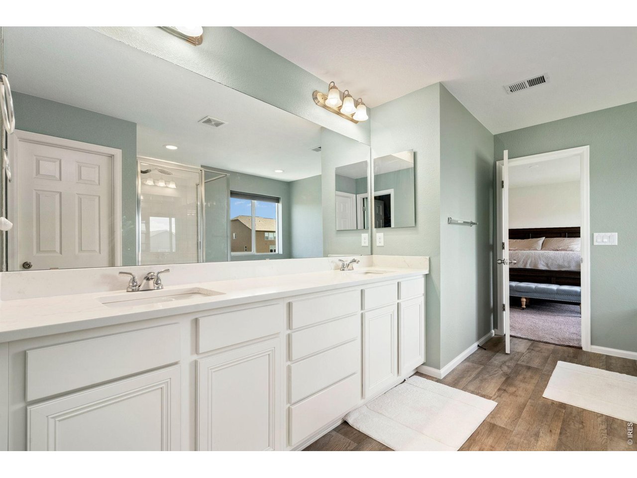 5259 Odessa Lake Street Timnath, CO 80547 - Photo 16 of 30 a bathroom with a sink double vanity and a mirror