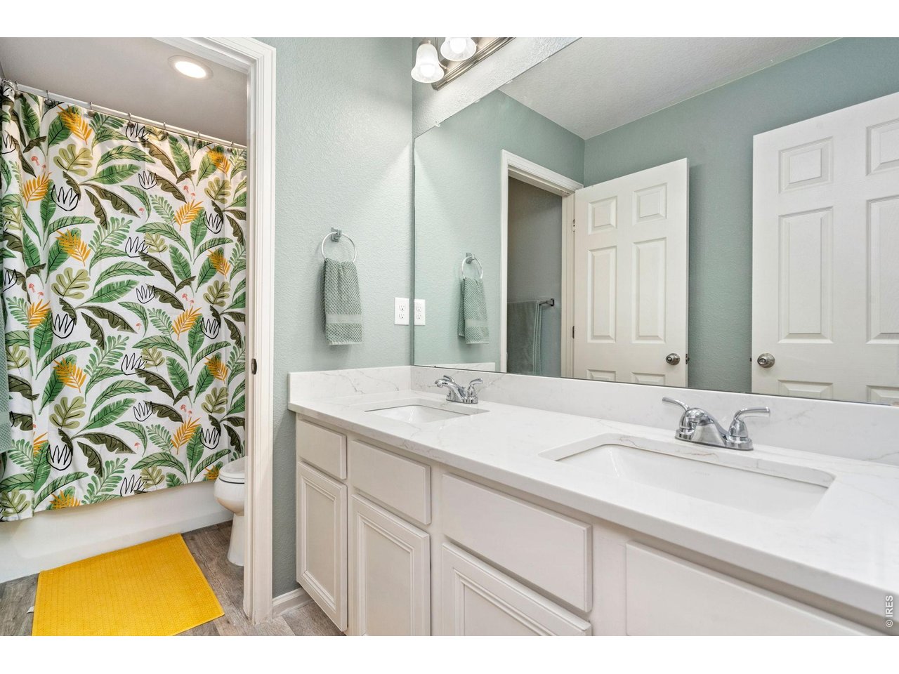 5259 Odessa Lake Street Timnath, CO 80547 - Photo 18 of 30 a bathroom with a sink and a mirror