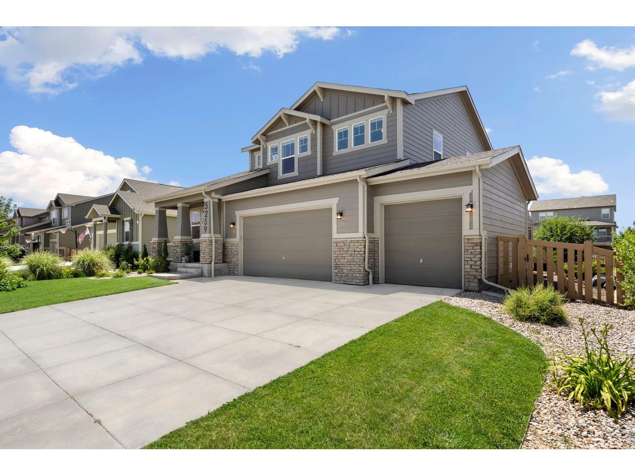 5259 Odessa Lake Street Timnath, CO 80547 - Photo 2 of 30 a front view of a house with a yard and garage