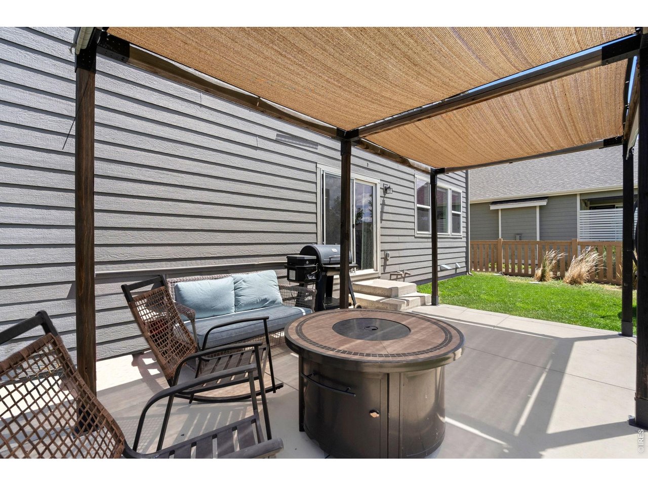 5259 Odessa Lake Street Timnath, CO 80547 - Photo 26 of 30 a view of a patio with table and chairs