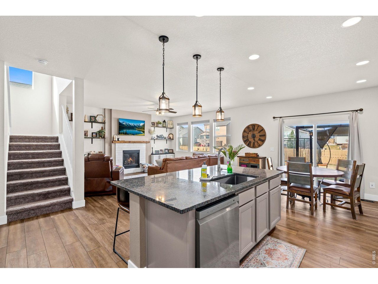 5259 Odessa Lake Street Timnath, CO 80547 - Photo 5 of 30 a kitchen with a table chairs and a chandelier
