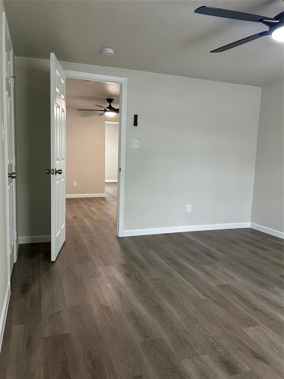 407 North Justin Avenue, Unit D Dallas, TX 75211 - Photo 3 of 15 wooden floor in an empty room