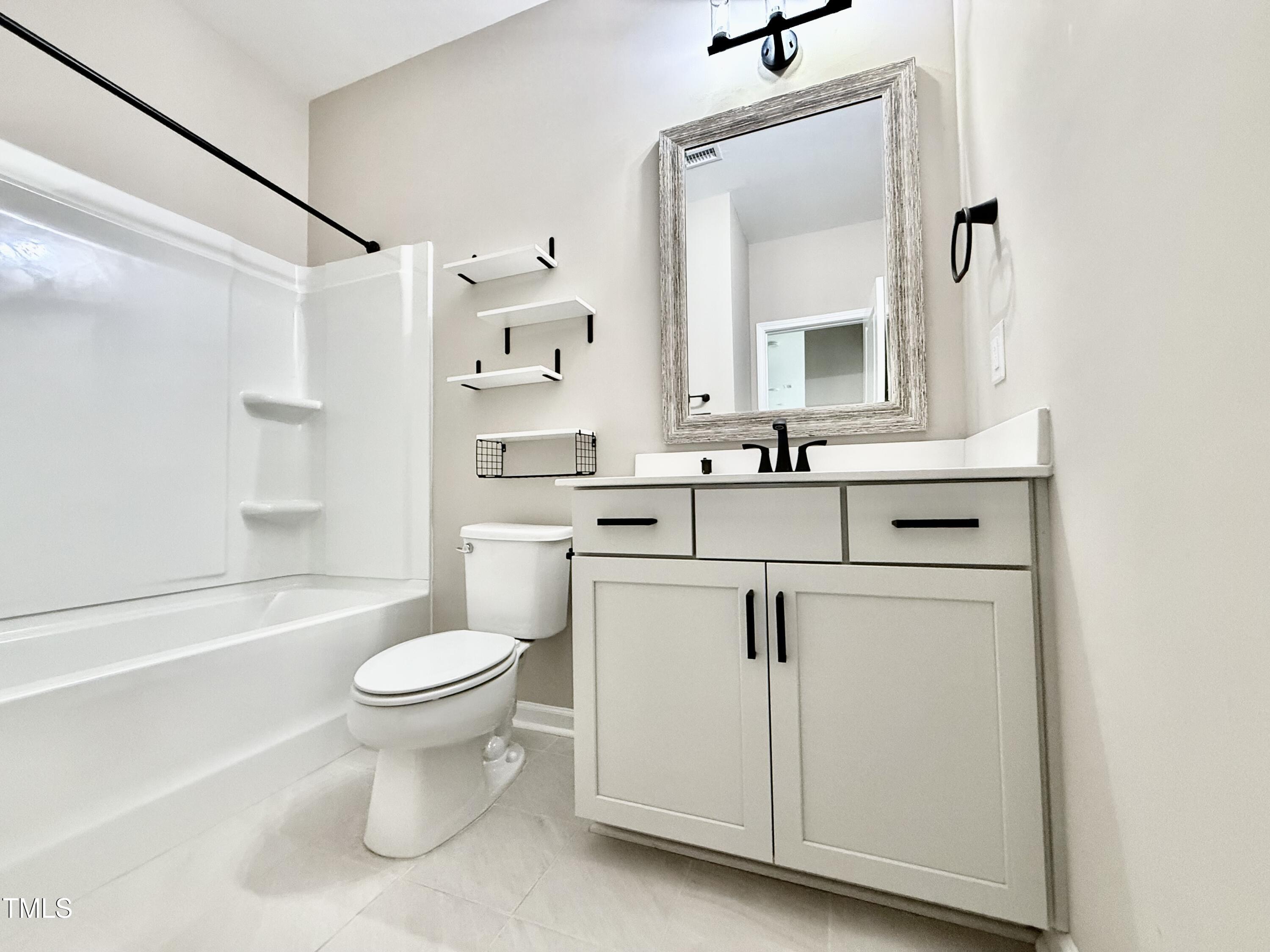 3904 Leeson Trail Raleigh, NC 27616 - Photo 18 of 43 a bathroom with a sink toilet vanity and shower