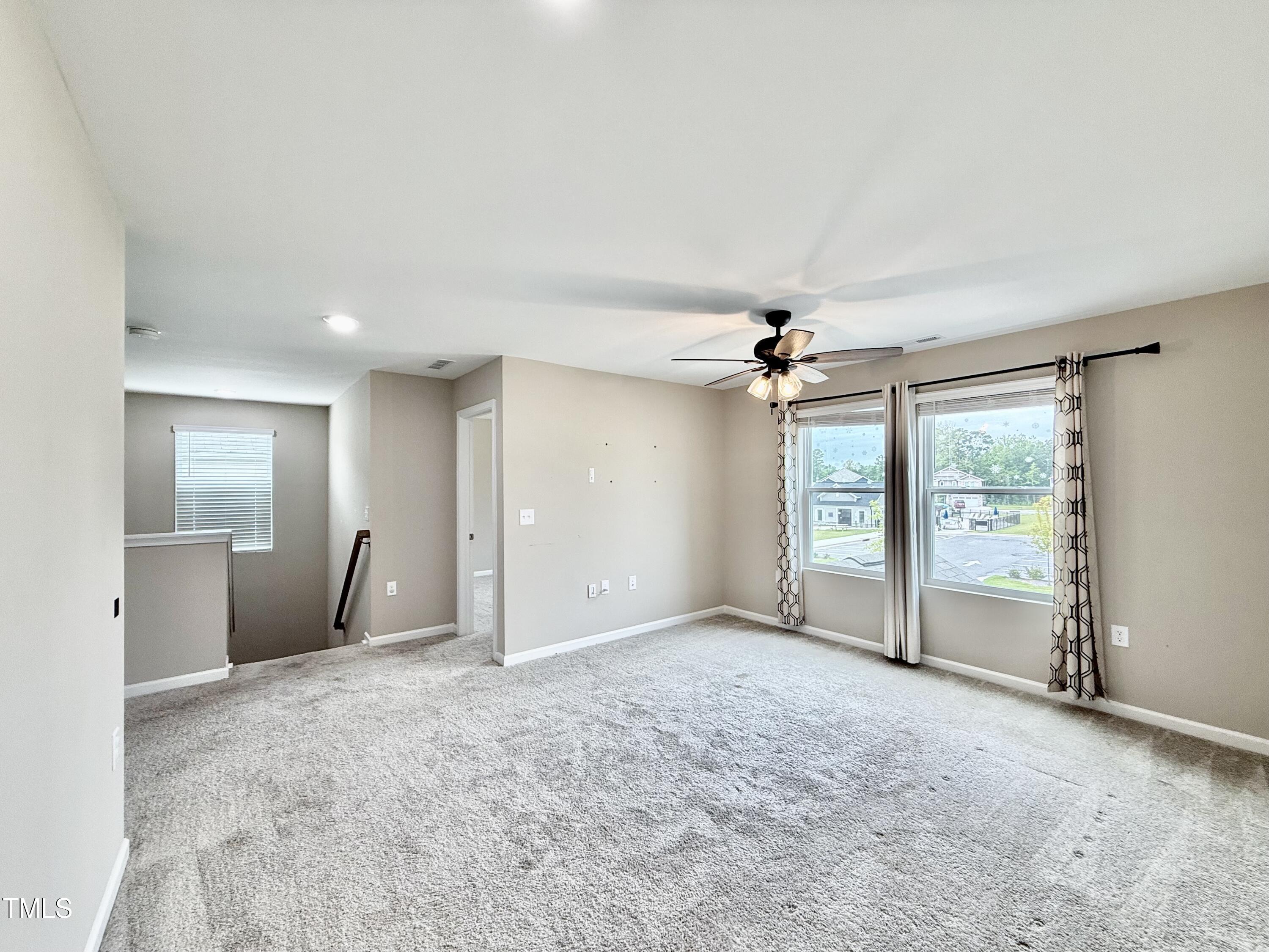 3904 Leeson Trail Raleigh, NC 27616 - Photo 23 of 43 an empty room with fan and windows
