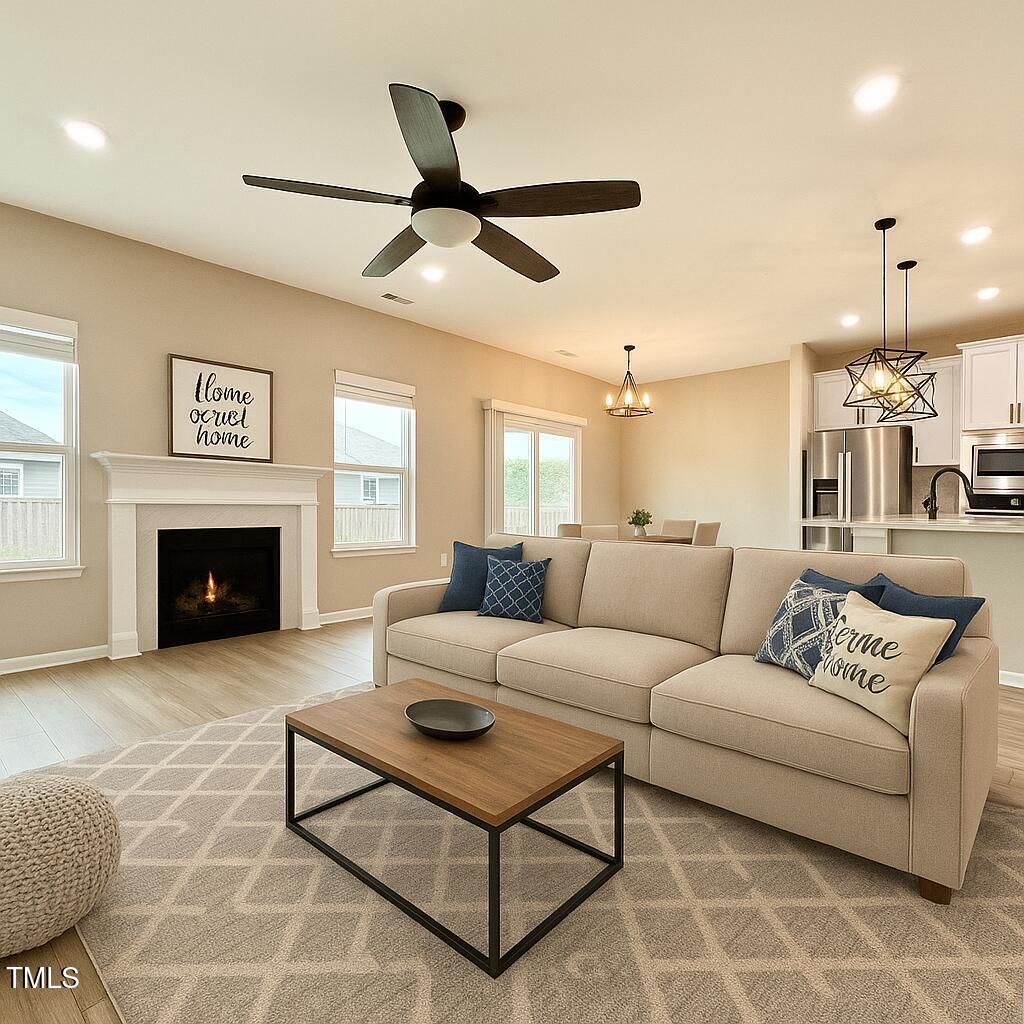3904 Leeson Trail Raleigh, NC 27616 - Photo 3 of 43 a living room with furniture a fireplace and a flat screen tv