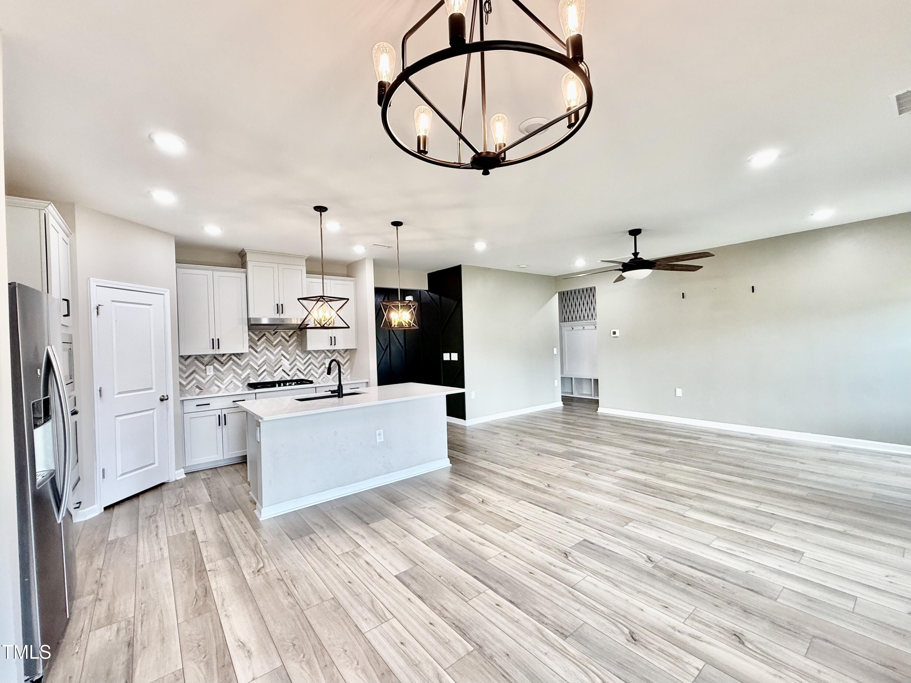 3904 Leeson Trail Raleigh, NC 27616 - Photo 7 of 43 a view of kitchen with stainless steel appliances refrigerator stove microwave and cabinets