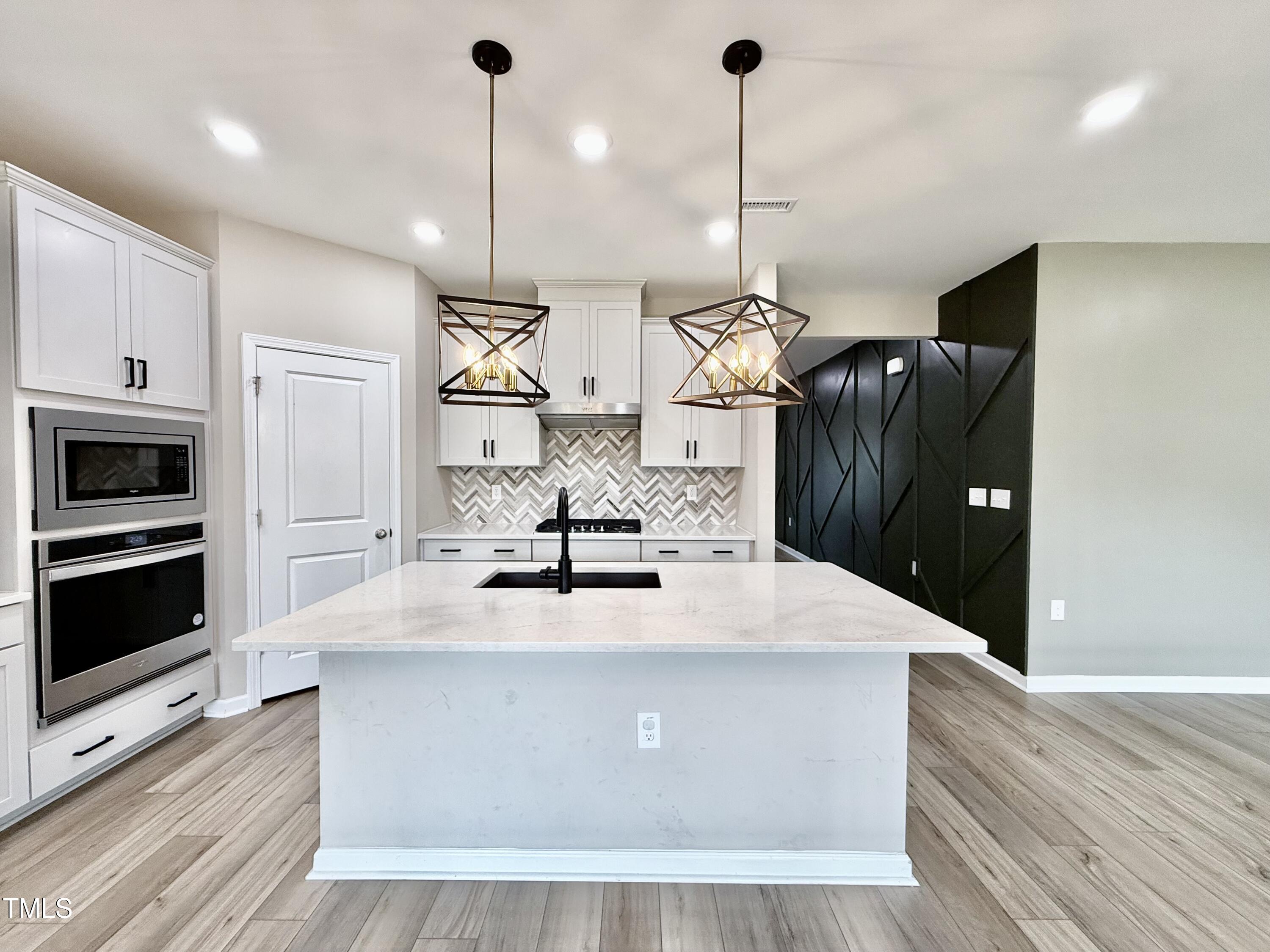 3904 Leeson Trail Raleigh, NC 27616 - Photo 10 of 43 a kitchen with kitchen island a counter top space appliances and cabinets