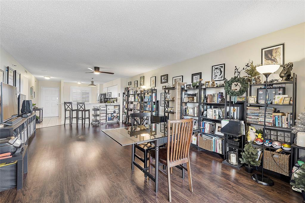 2240 North Cypress Bend Drive, Unit 908 Pompano Beach, FL 33069 - Photo 12 of 66 a view of a livingroom with furniture and a book shelf
