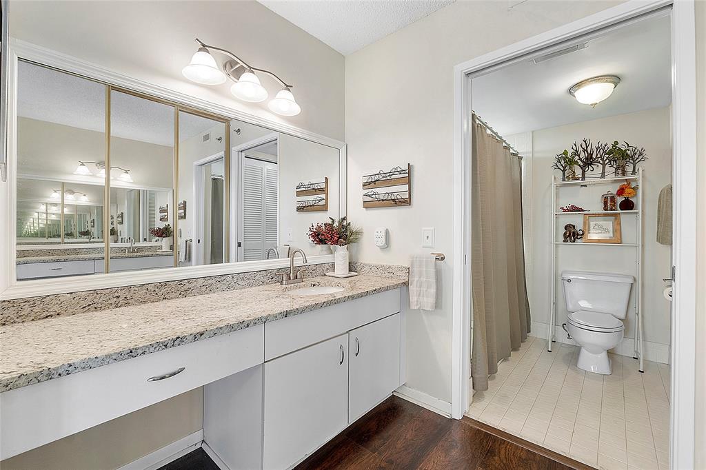 2240 North Cypress Bend Drive, Unit 908 Pompano Beach, FL 33069 - Photo 16 of 66 a bathroom with a granite countertop sink mirror and toilet