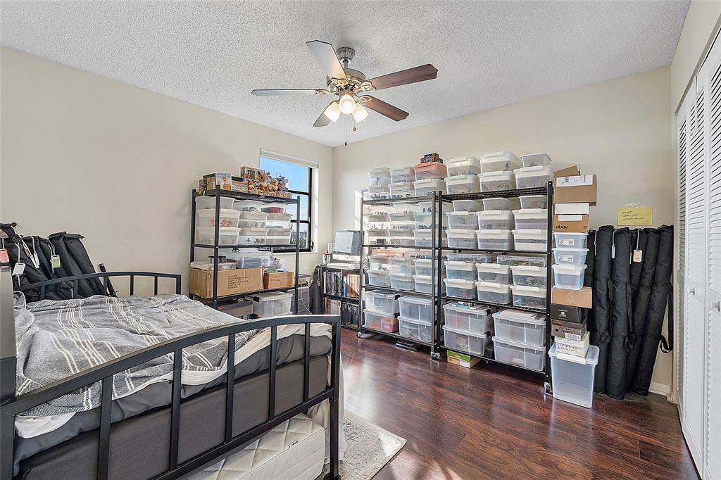 2240 North Cypress Bend Drive, Unit 908 Pompano Beach, FL 33069 - Photo 20 of 66 a bedroom with a bed with wooden floor