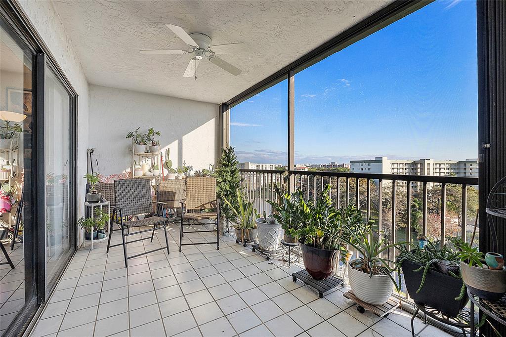2240 North Cypress Bend Drive, Unit 908 Pompano Beach, FL 33069 - Photo 26 of 66 a view of a balcony with chairs