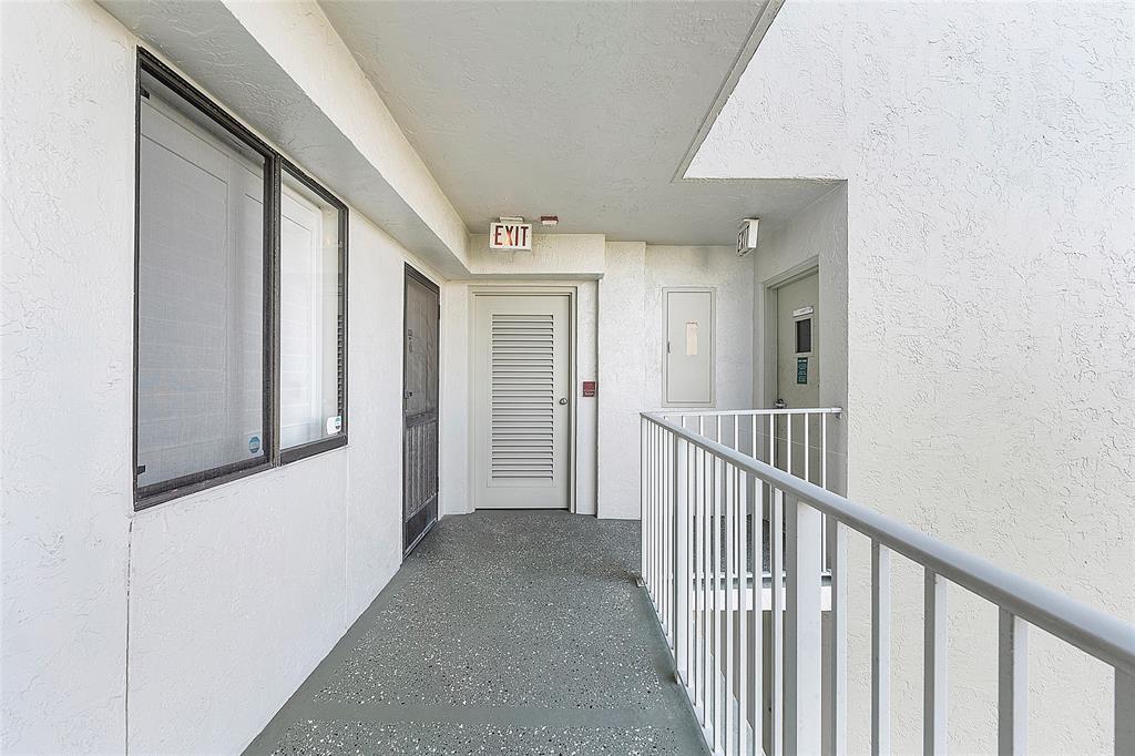 2240 North Cypress Bend Drive, Unit 908 Pompano Beach, FL 33069 - Photo 28 of 66 a view of a hallway with wooden floor and entryway