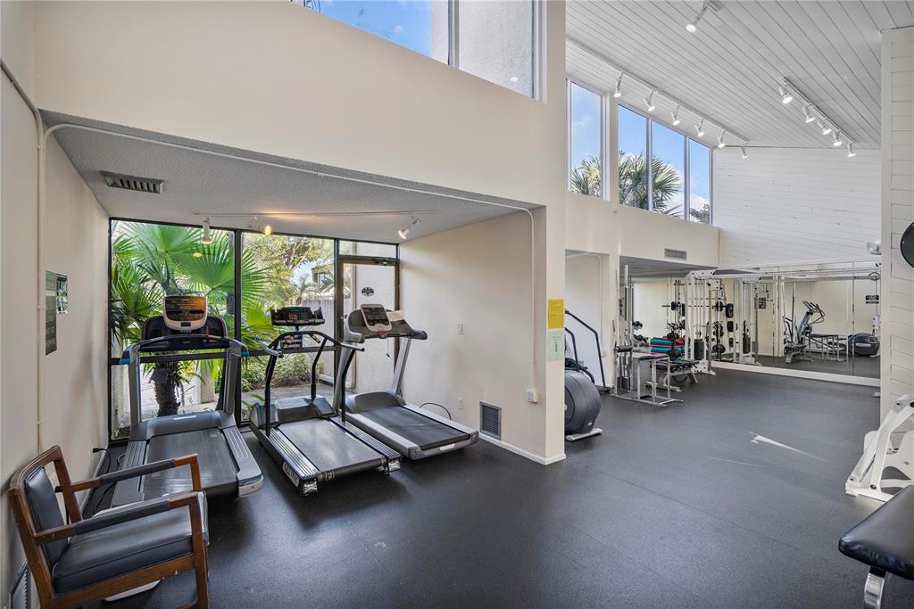 2240 North Cypress Bend Drive, Unit 908 Pompano Beach, FL 33069 - Photo 64 of 66 a view of a room with gym equipment