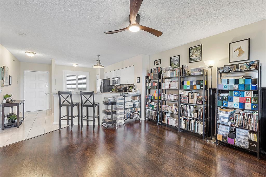 2240 North Cypress Bend Drive, Unit 908 Pompano Beach, FL 33069 - Photo 8 of 66 a view of a livingroom with furniture and wooden floor