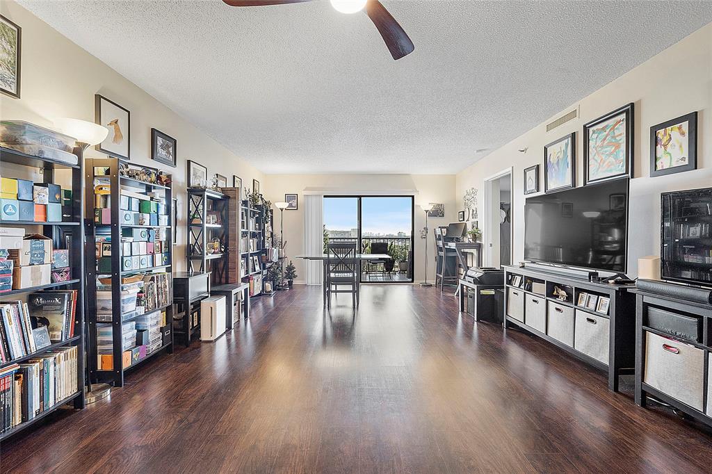 2240 North Cypress Bend Drive, Unit 908 Pompano Beach, FL 33069 - Photo 9 of 66 a living room with lots of furniture and wooden floor