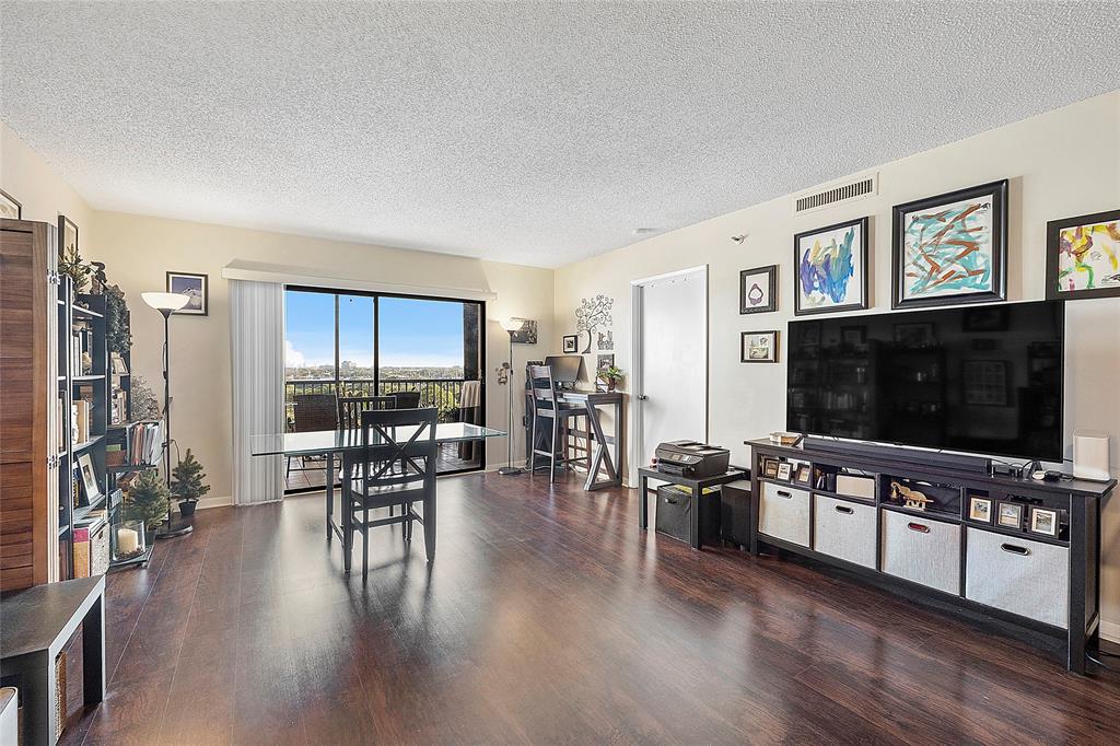 2240 North Cypress Bend Drive, Unit 908 Pompano Beach, FL 33069 - Photo 10 of 66 a living room with furniture and a flat screen tv